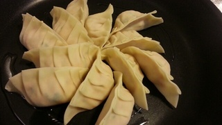 餃子の皮で具を包んで、油をひいたフライパンに並べていく。(まだ火は着けない)